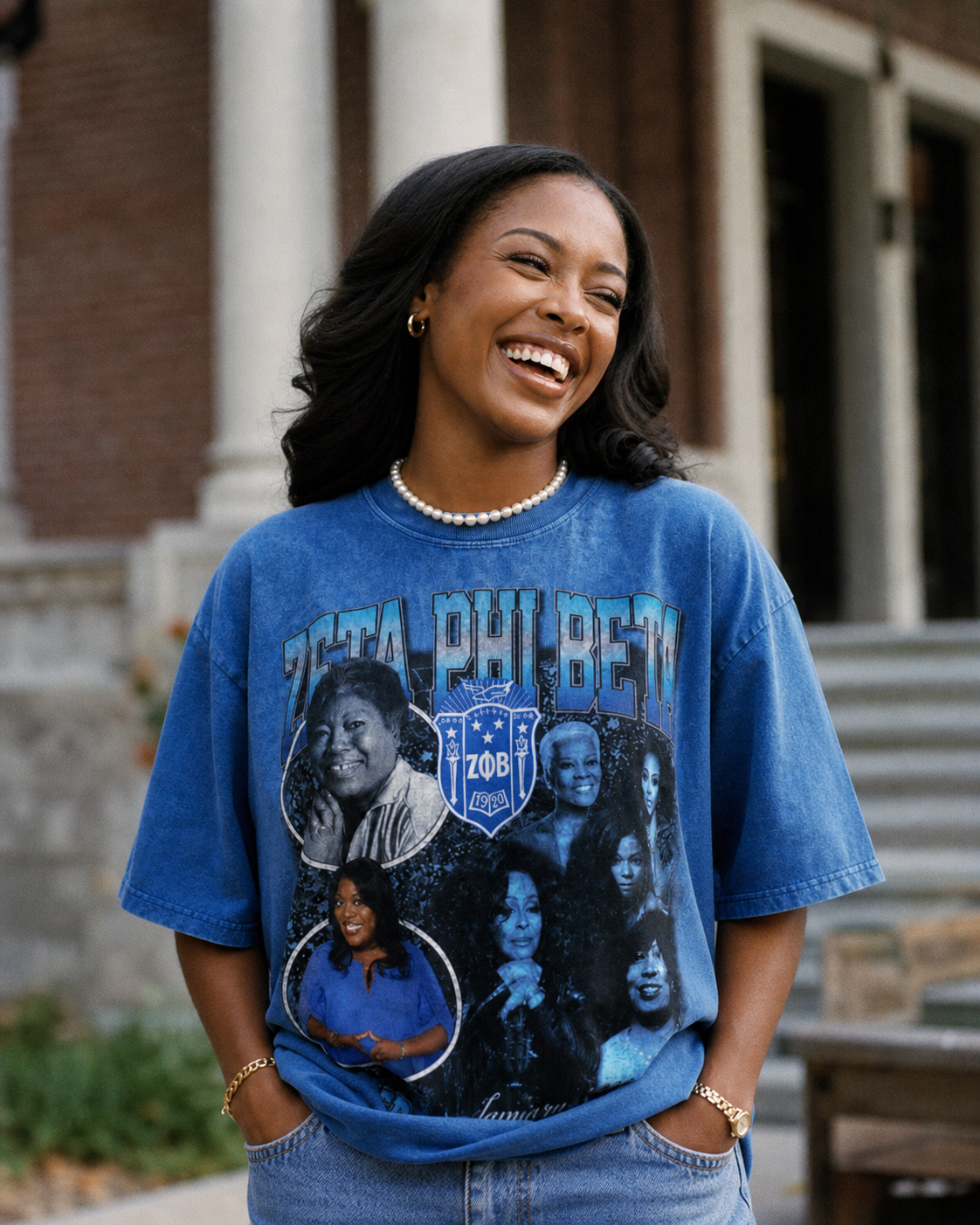 Woman wearing a blue t-shirt with graphic design in front of a building
